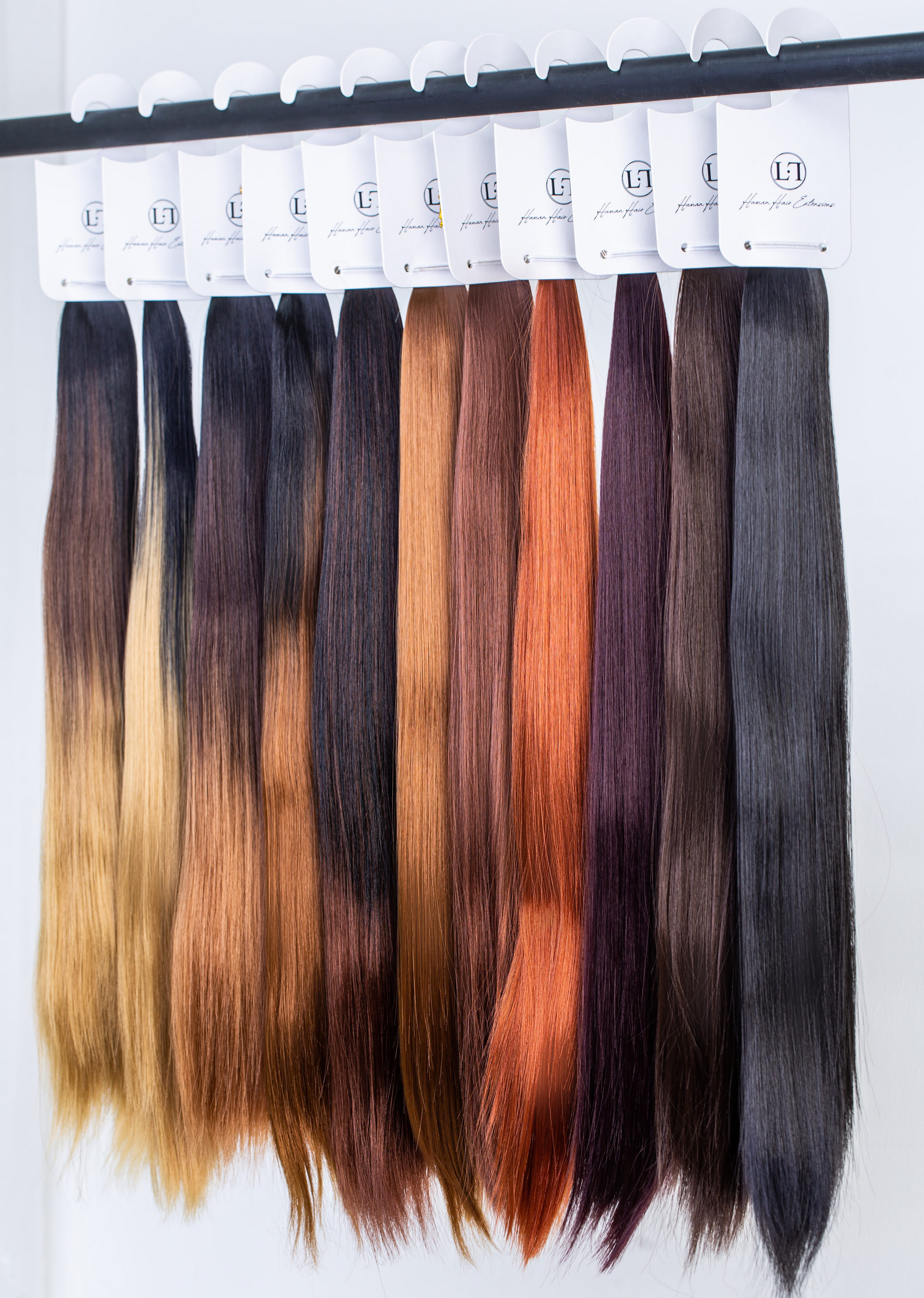 Set of hair extensions in various colors on a white background